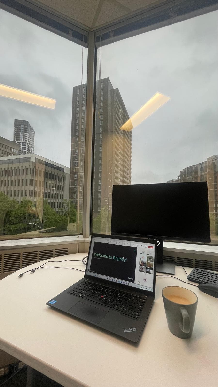 A favorite desk at the Brightly office overlooking city buildings